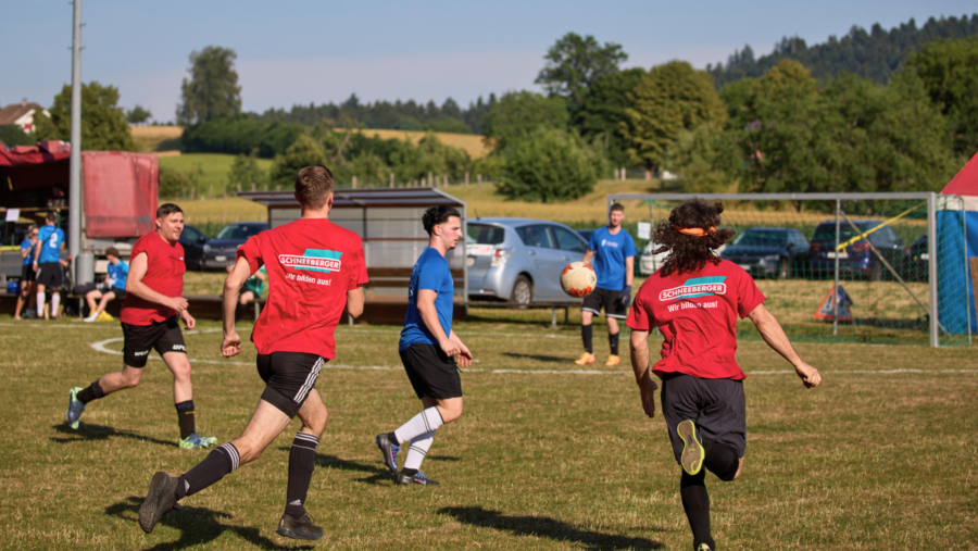 Full commitment: Three players closing in on the ball